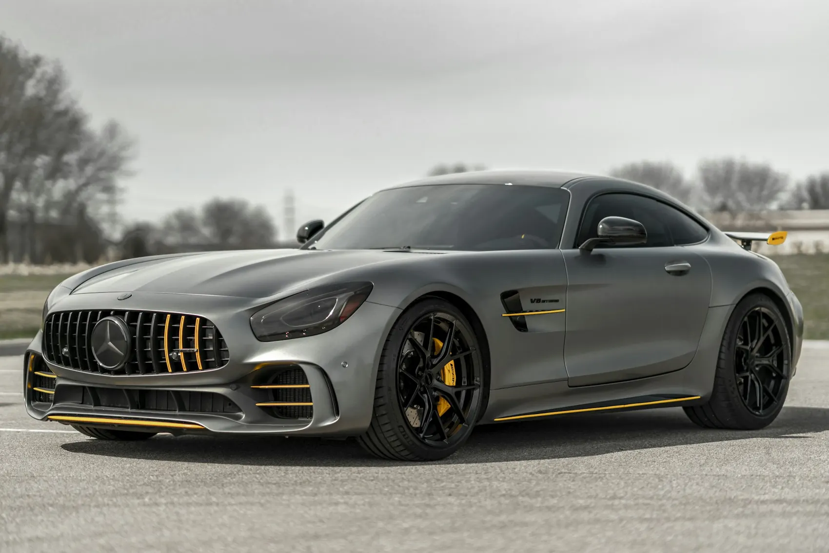 Grey sports coupe with freshly polished, glossy paint.