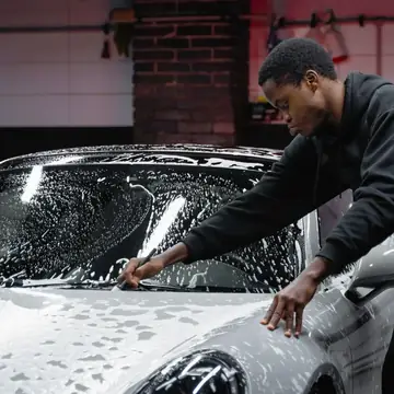 Brushing snow foam over a car