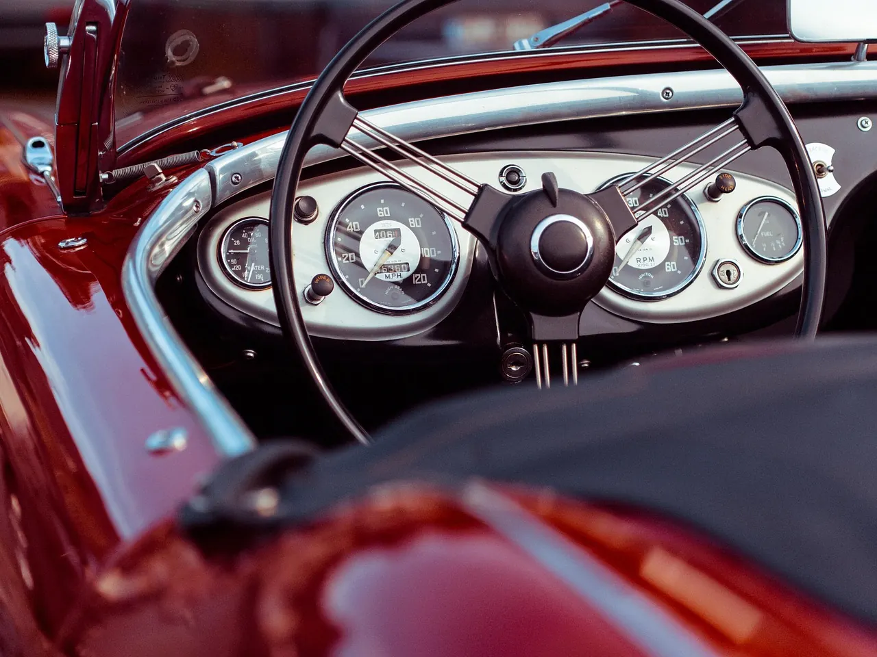 Clean classic car dashboard and steering wheel.
